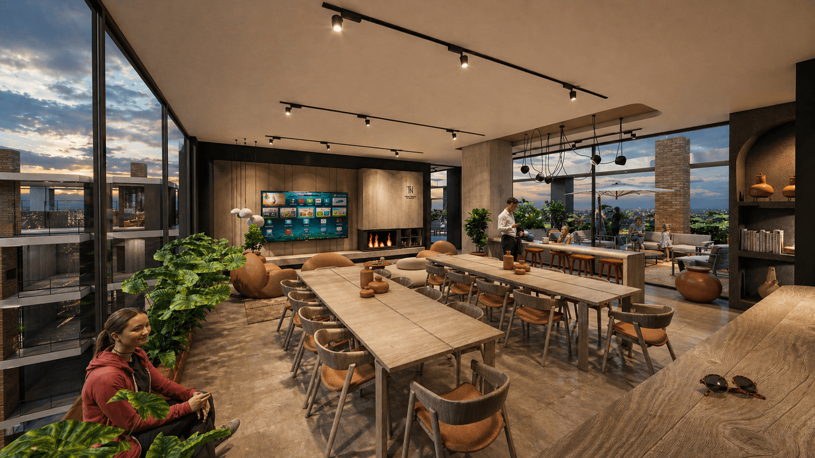 Espace coworking avec tables de travail, salon et terrasse dans la résidence Narciso La Cuadrita à Asunción au Paraguay.